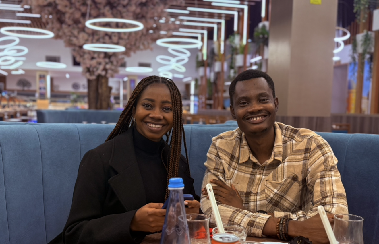 Oluwasefunmi and Olanrewaju smiling at dinner