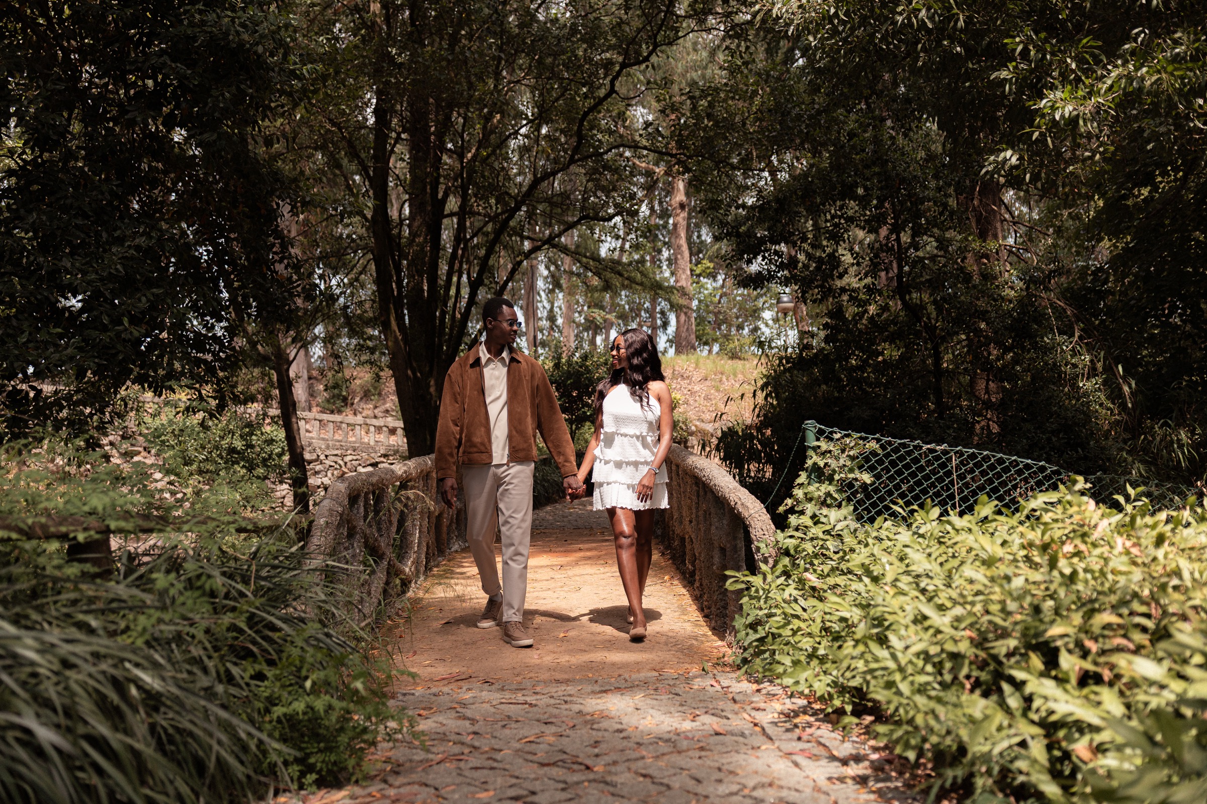 Oluwasefunmi and Olanrewaju walking together on a garden bridge